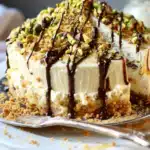 Limoncello Mascarpone Ricotta Cake with Pistachio Crunch and Chocolate Drizzle